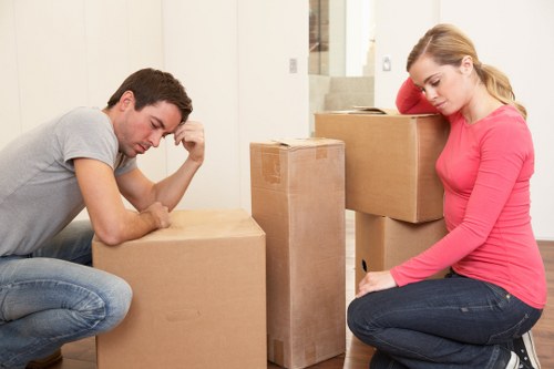House movers carrying furniture through a West Kensington property