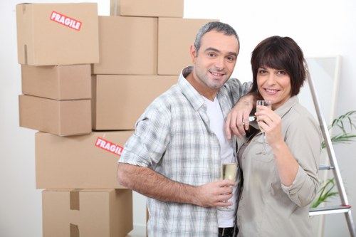 Professional moving team handling boxes and furniture in West Kensington