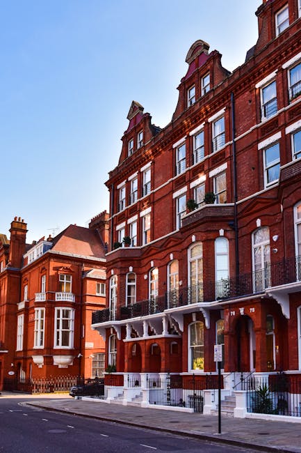 A rectangular metal street sign mounted on a red brick wall displaying the words 'WELCOME TO SOUTH KENSINGTON SW7' in black and red lettering. The sign features a white background with black text for 